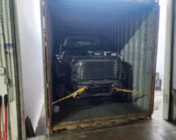 Toe truck dismantled to fit container.